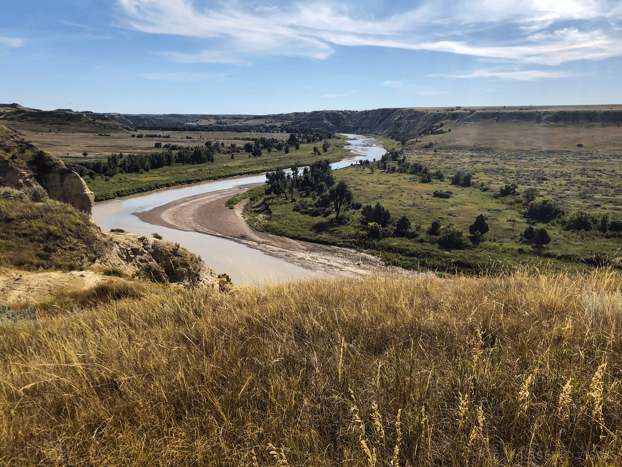 Grasslands in front of a bend in the Little Missouri River along the North Achenbach Trail